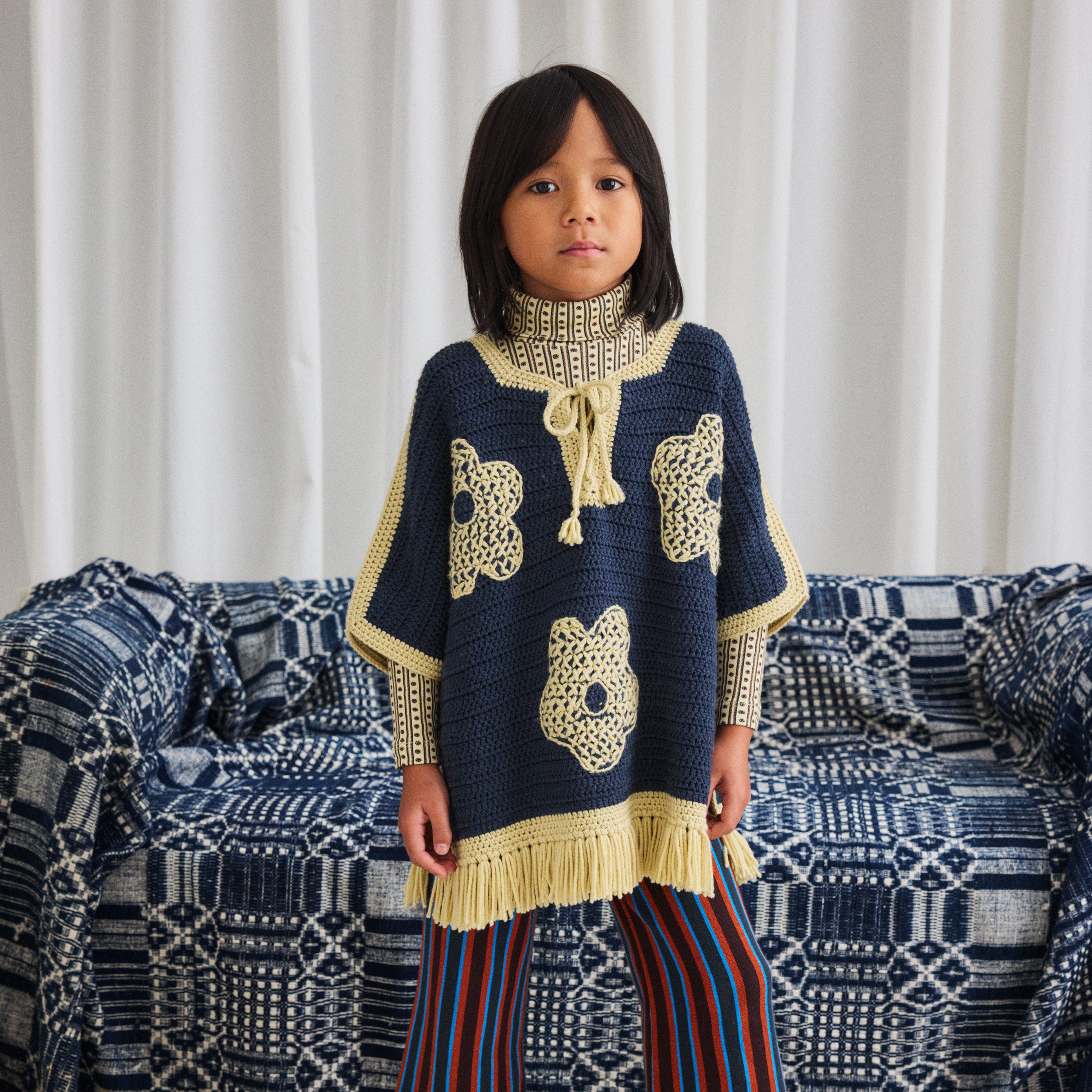 Merino Wool Crochet Blomma Fringe Poncho in blue in sizes 2y-10y Merino Wool Crochet Blomma Fringe Poncho in blue in sizes 2y-10y